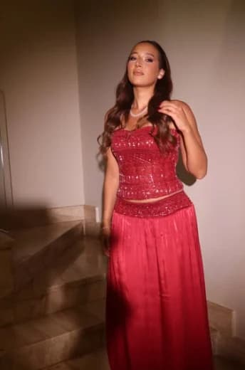 Ruby sequinned strapless corset with a satin maxi skirt, on a marble staircase